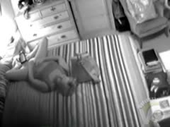 A bored housewife engages in orgasmic masturbation in the bedroom.